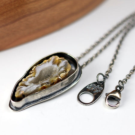 silver and gold pendant with agate slice