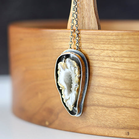 silver and gold pendant with agate slice