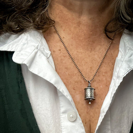 sterling silver hollow form pendant on beaded chain