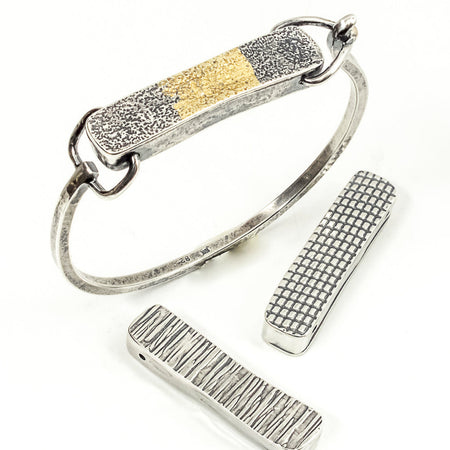silver and gold tension cuff bracelet