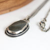 Silver necklace with a pendant on a white background