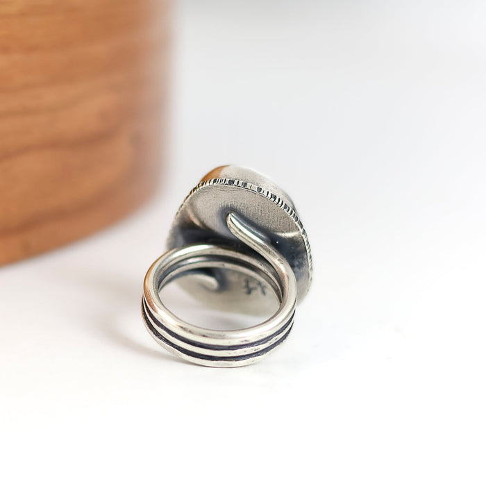 silver ring with a coil band on a white background