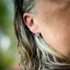 small sterling silver leaf stud earrings on ear