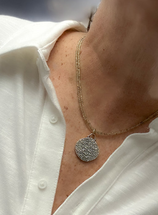 faceted sapphire beaded necklace with sterling silver hollow form pendants