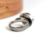 Silver ring with textured surface on a white background