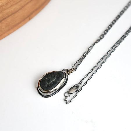 Necklace with a stone pendant on a white background