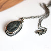 Necklace with a  beach stone pendant on a white surface