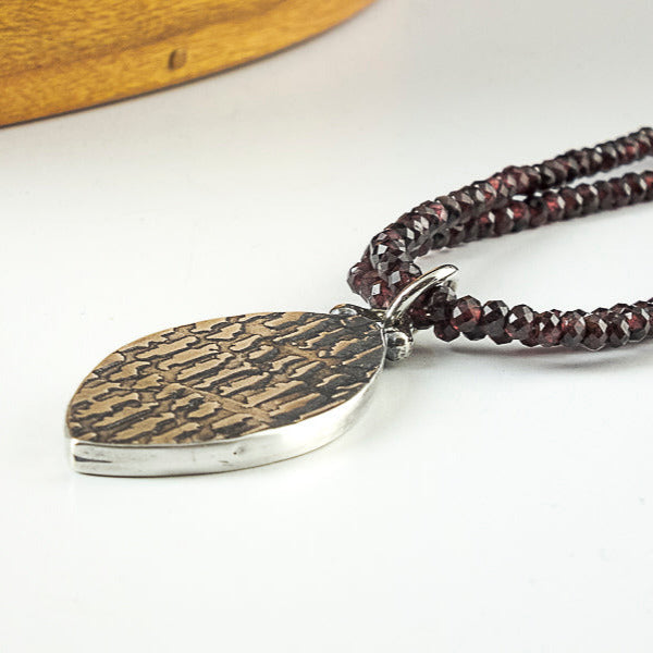 faceted garnet bead necklace with sterling silver hollow form