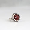 Handmade sterling silver ring with horizontal rose cut hessonite garnet, dot textured bezel border and half round comfort fit band, size 7
