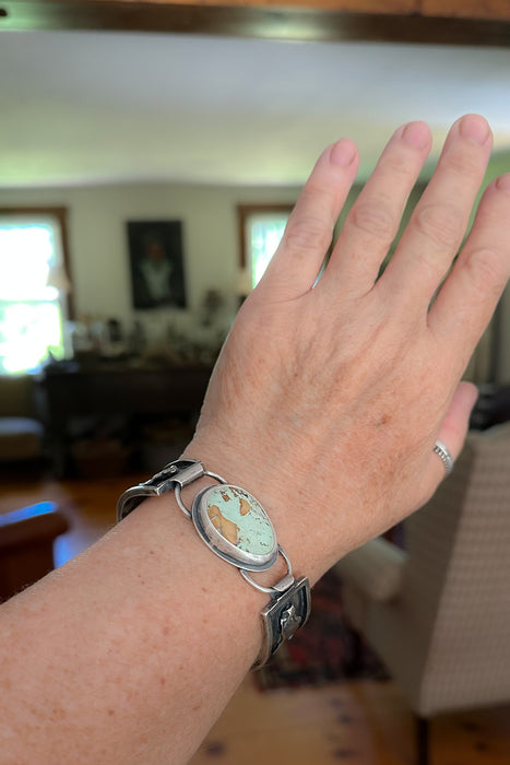 Sterling silver cuff bracelet with Royston turquoise from Nevada, reticulated silver detail, patina finish, handmade by LjB Jewelry, shown on wrist