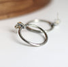 Silver hoop earrings on a light background