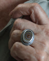 silver fordite ring worn on a hand