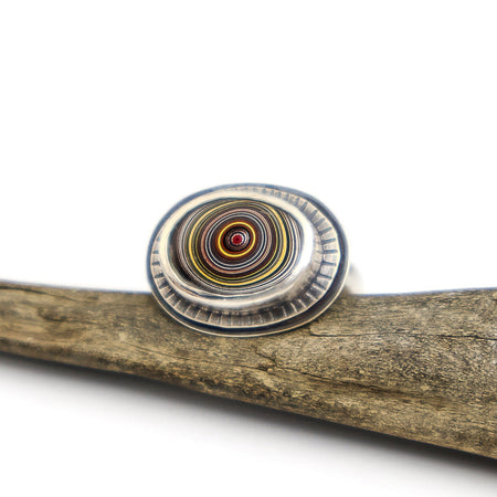 Silver ring with fordite cabochon