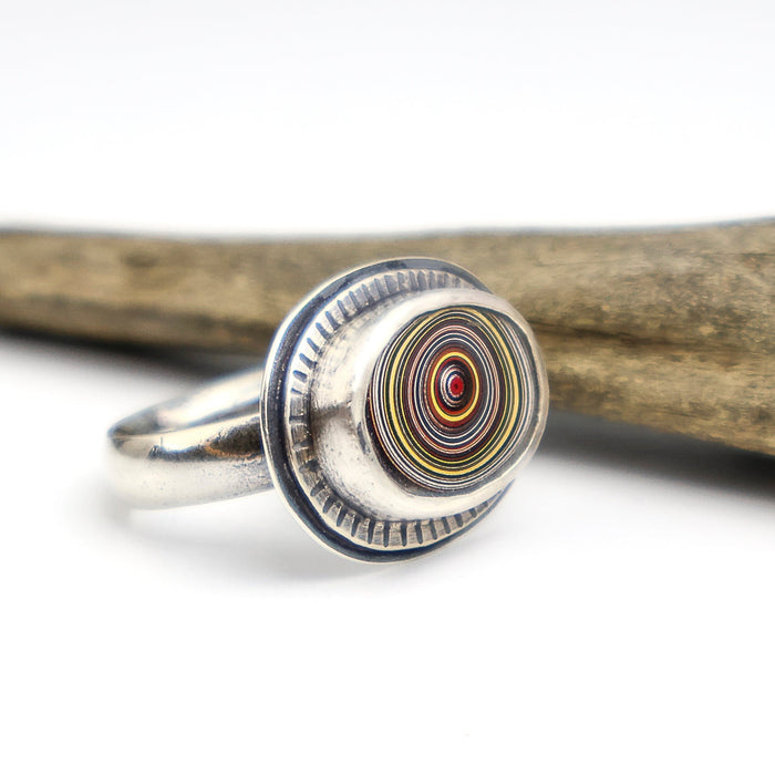 sterling silver ring with a bezel set fordite cabochon
