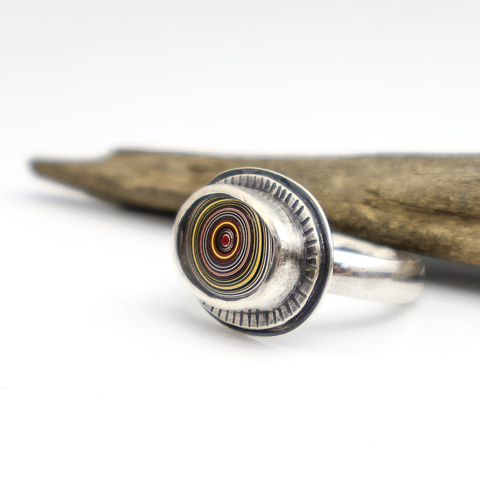 sterling silver ring with a bezel set fordite cabochon