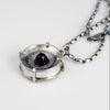 Handmade sterling silver pendant with high dome amethyst in a sand textured flower frame inside a pronged silver cup, on an oval bead chain