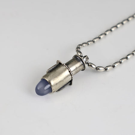 Handmade sterling silver tube pendant with riveted nesting tubes holding a lavender blue chalcedony point, oxidized patina, on an oval bead chain