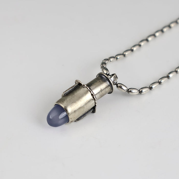 Handmade sterling silver tube pendant with riveted nesting tubes holding a lavender blue chalcedony point, oxidized patina, on an oval bead chain