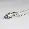Handmade sterling silver tube pendant with riveted nesting tubes holding a lavender blue chalcedony point, oxidized patina, on an oval bead chain