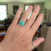 Sterling silver split shank ring on a hand  with soft green Emerald Valley turquoise from Nevada, line textured band, handmade by LjB Jewelry
