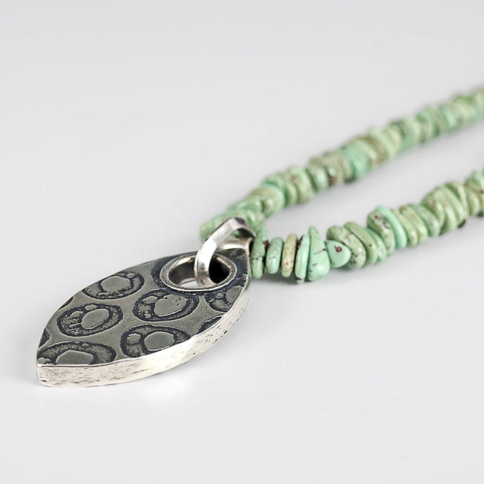 turquoise beaded necklace with silver textured pendant