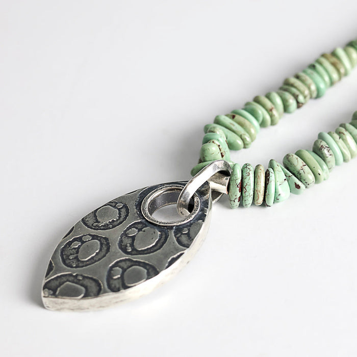 turquoise beaded necklace with silver textured pendant