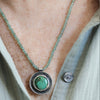 Sterling silver hollow form pendant on a person with Emerald Valley turquoise from Nevada on faceted green apatite bead strand, handmade by LjB Jewelry