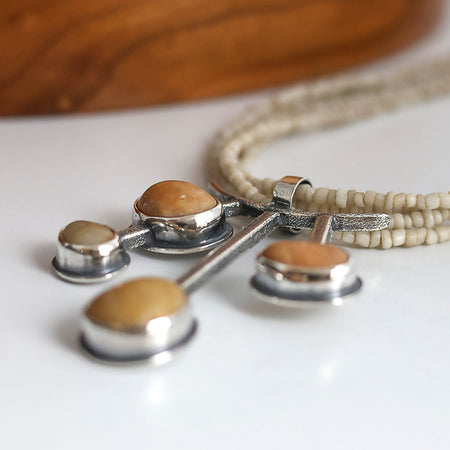 yellow beach stone pendant in sterling silver with a white maasai bead necklace