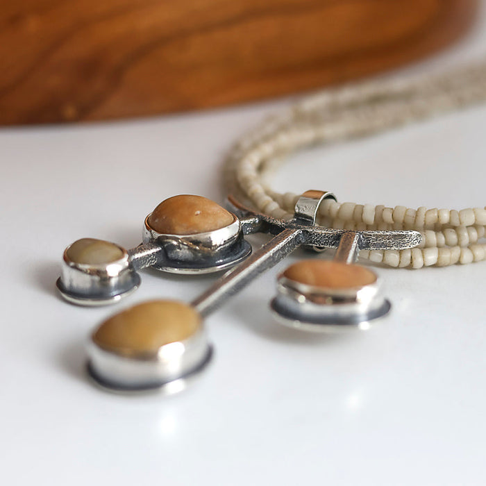 yellow beach stone pendant in sterling silver with a white maasai bead necklace