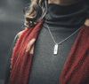 silver necklace on neck