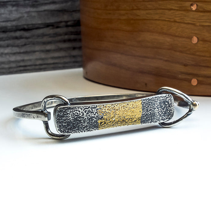 silver and gold tension cuff bracelet