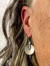 silver dangle earrings on ear